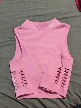 pink Nike Pro Dri-FIT crop top featuring distinctive side-cutout details
